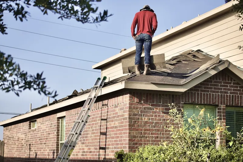 Professional roofer working on a residential roof in Attica